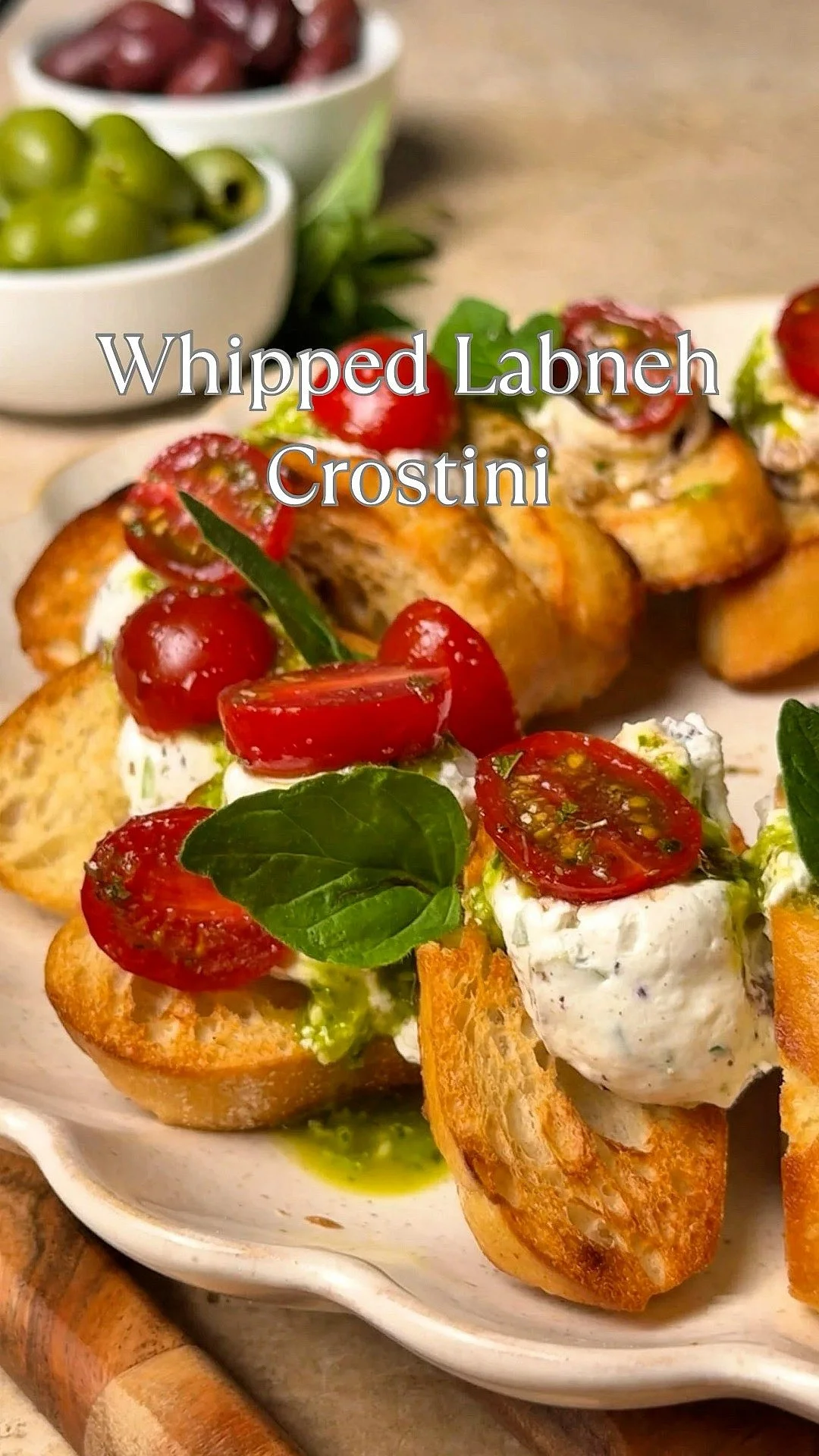 Whipped labneh crostini wreath garnished with herbs and colorful toppings